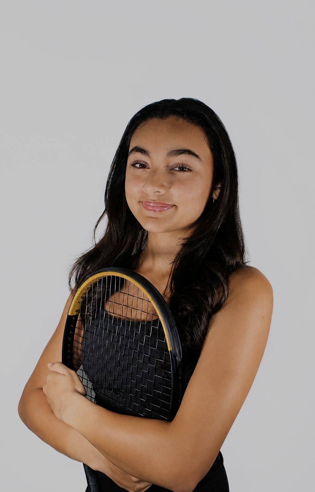 Riddhi Thakur holding a tennis racket for her 2026 All-Area portrait